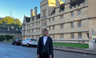 A person standing infront of an ancient building